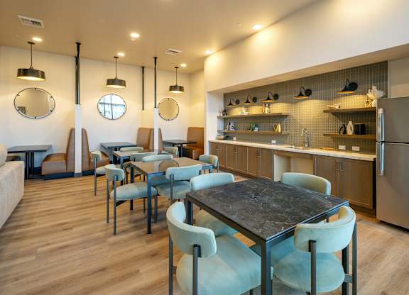 A modern dining area with a table and chairs.