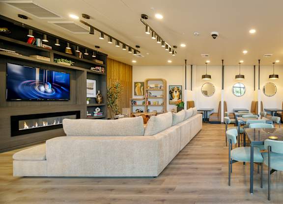 A modern room with a long white sofa.