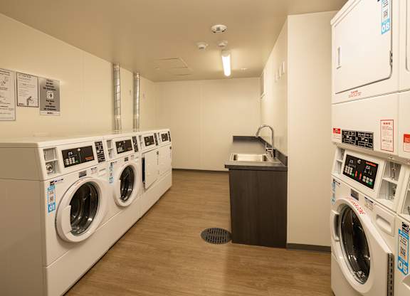 A row of washing machines in a laundromat.