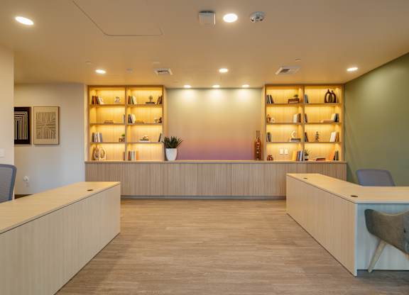 A reception area with a long counter and chairs.