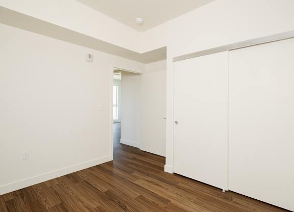 A room with a white door and a window.
