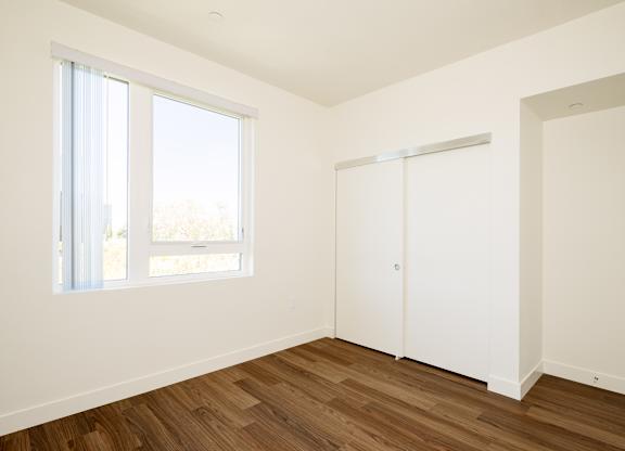 A room with a sliding door and a window.