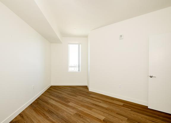 A room with wooden floors and white walls.