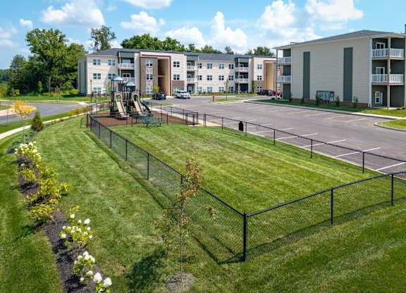 A view of apartment buildings with a playground in the foreground.