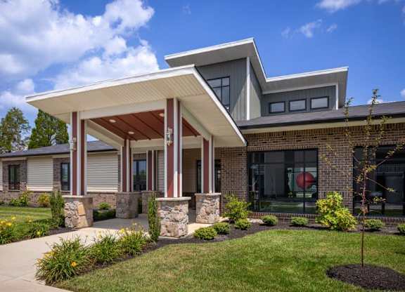 A modern house with a white roof and a covered porch.