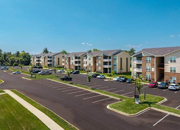 A parking lot in front of apartment buildings.