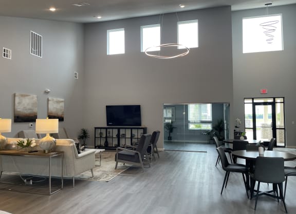 a large living room with a table and chairs and a television