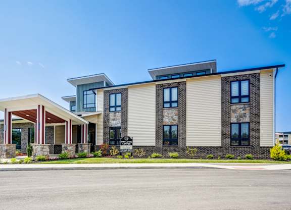 A modern two-story building with a mix of stone and siding exterior.