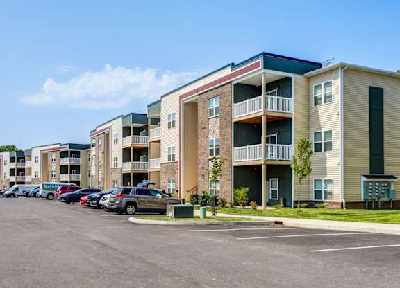 A parking lot in front of apartment buildings.