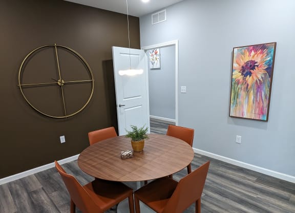 a dining room with a wooden table and orange chairs