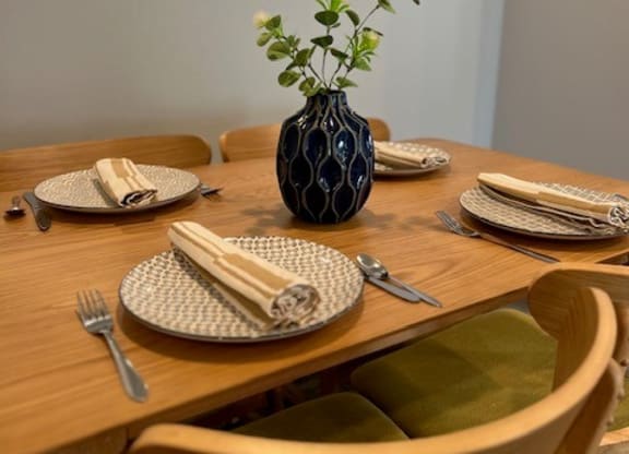 a table with plates and a vase with a plant