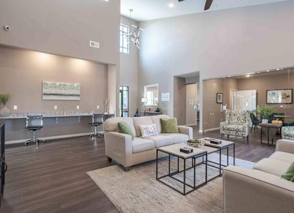 A spacious living room with a white sofa and a coffee table.