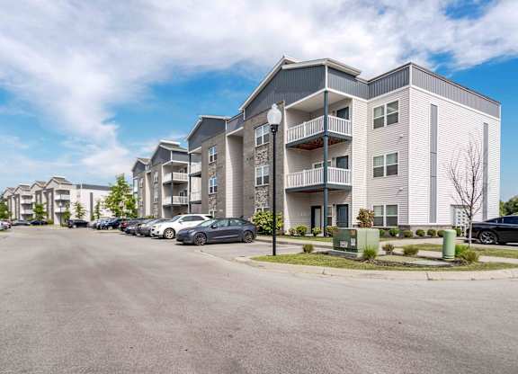 A parking lot in front of apartment buildings.