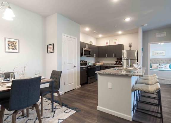 A kitchen with a bar area and a dining table.
