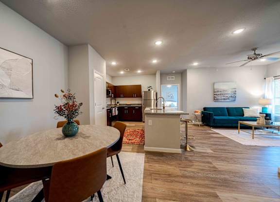 a dining room with a table and chairs and a living room