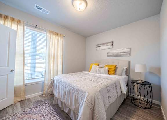 a bedroom with a bed and a window