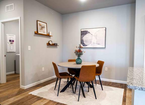 a dining room with a table and chairs