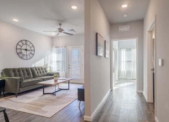 A living room with a grey couch and a wooden coffee table.