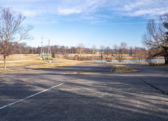 A large open parking lot with a clear blue sky above.