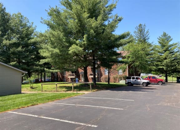 a parking lot with cars in front of a brick building