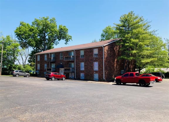 a large brick building with cars parked in front of it