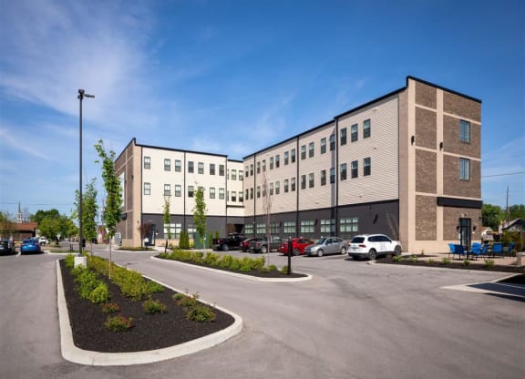 an empty parking lot in front of an apartment building