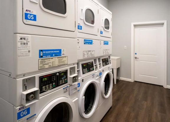 a row of washing machines in a laundry room