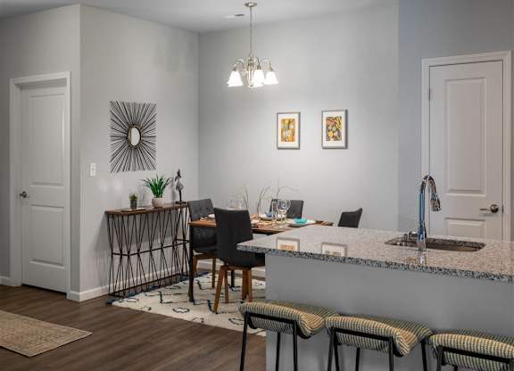 a kitchen and dining room with a table and chairs