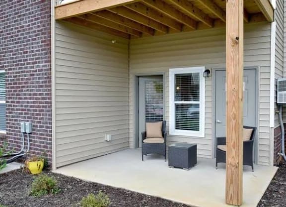 a porch with a chair and a table on it