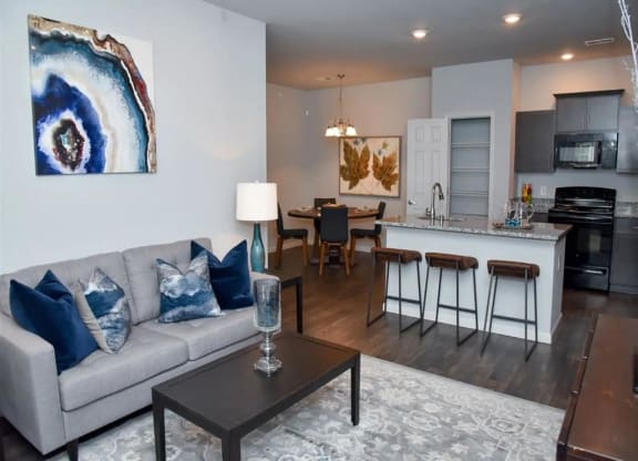 a living room and kitchen with a couch and a table