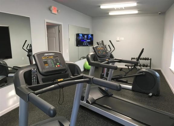 the gym in our new building is equipped with a treadmill and a tv