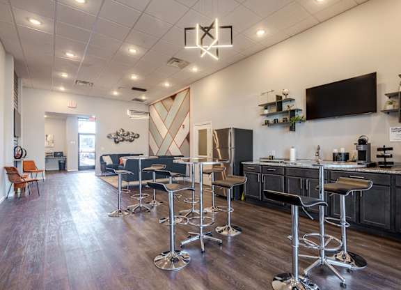 A bar area with a row of stools and a counter.