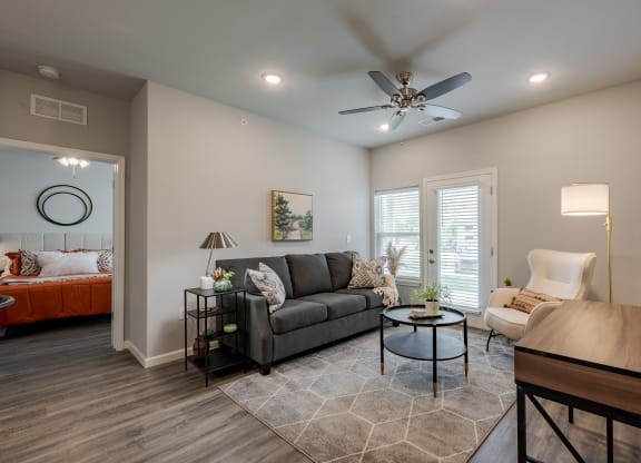 a living room with a couch and a ceiling fan