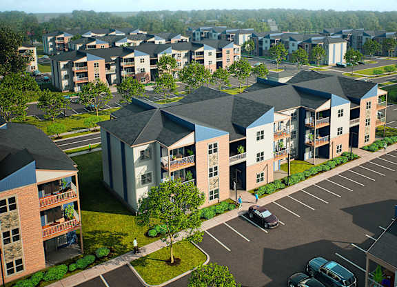 A parking lot in front of apartment buildings.