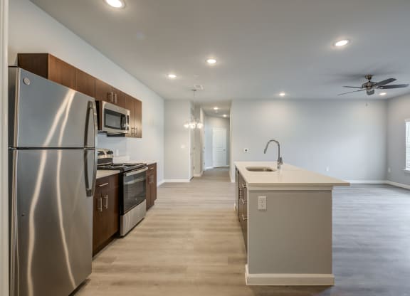 a kitchen with stainless steel appliances and a white counter top