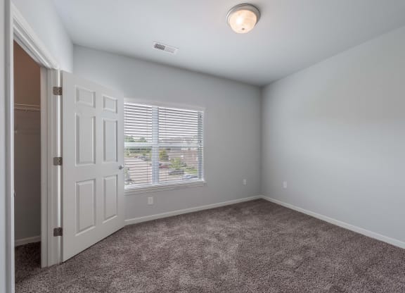 an empty room with a door and a window