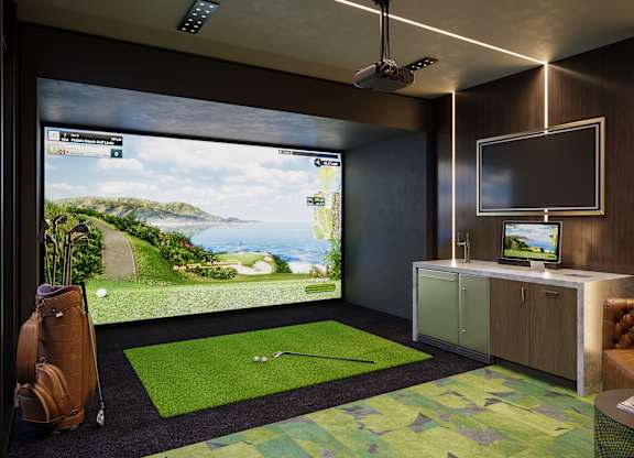 A room with a golf simulator and a television.