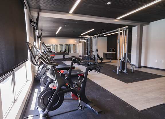 A gym with a row of stationary bikes and a variety of other equipment.at The Franklin at Westfield, Westfield, NJ 07090