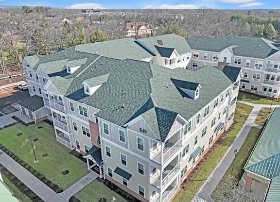 an aerial view of an apartment building with green roofs at The Franklin at Hillsborough Apartments, Hillsborough, NJ