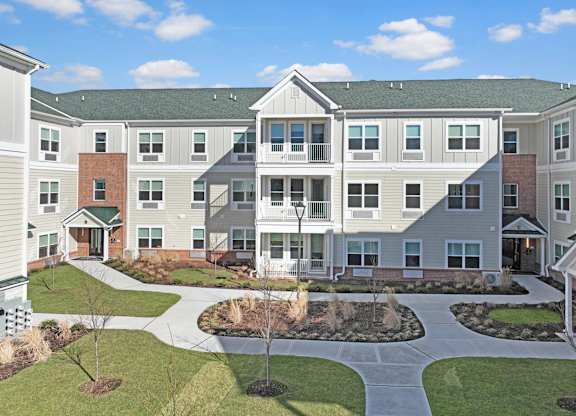 an exterior view of an apartment building with a courtyard at The Franklin at Hillsborough Apartments, NJ,08844