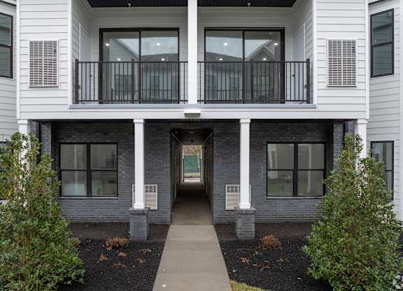 A white two-story building with a balcony at The Franklin at Marlboro, Marlboro, NJ, 07746
