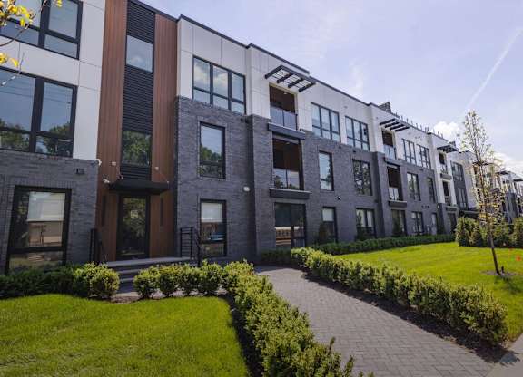 a row of modern apartment buildings with a sidewalk and grass at The Franklin at Westfield, Westfield, NJ 07090