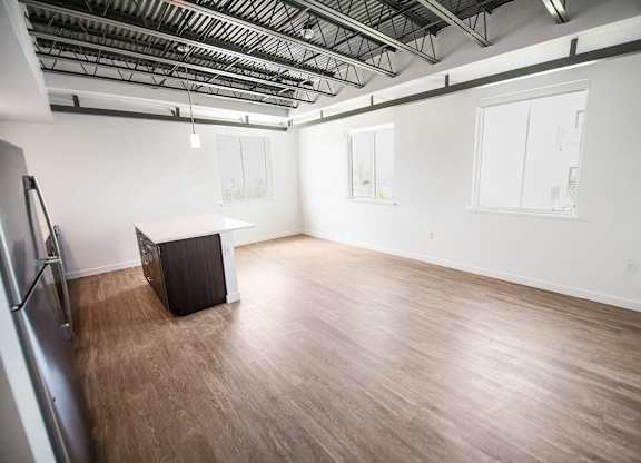 A room with wooden flooring and a black box on the floor at Elements on Third Apartments, St. Petersburg, FL