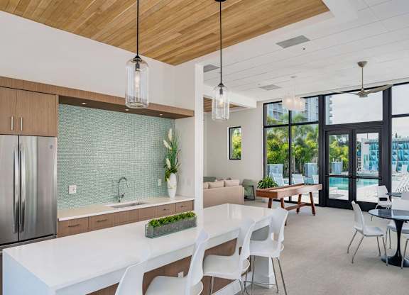 a large kitchen with a white table and chairs at Elements on Third Apartments, Florida, 33713