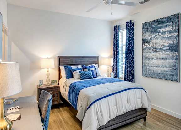 a bedroom with a bed and a ceiling fan at Elements on Third Apartments, St. Petersburg, Florida