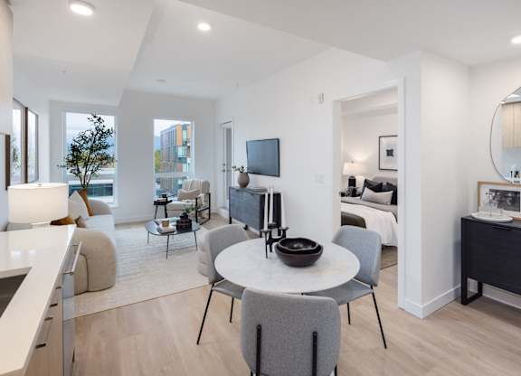 a living room with a table and chairs