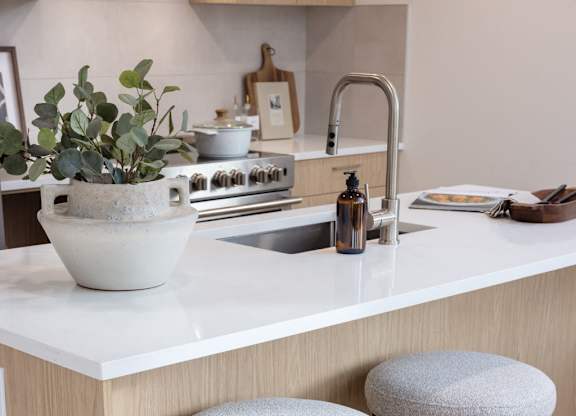 two stools sitting under a counter in a kitchen