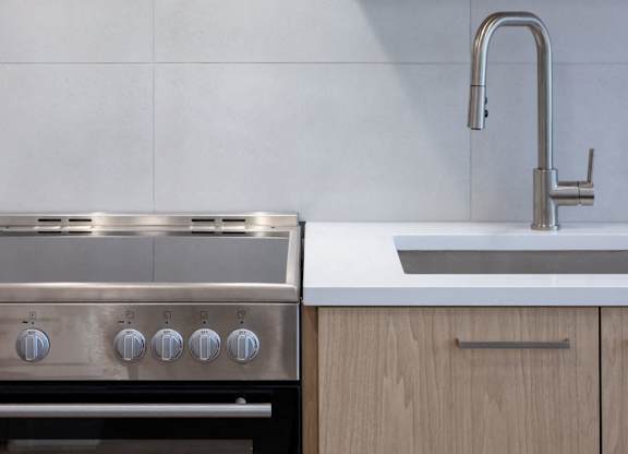 a kitchen with wooden cabinets and a sink and a faucet