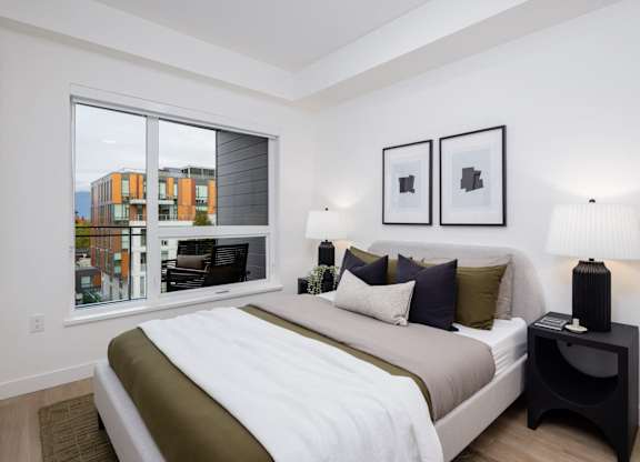 a bedroom with a large bed and a large window