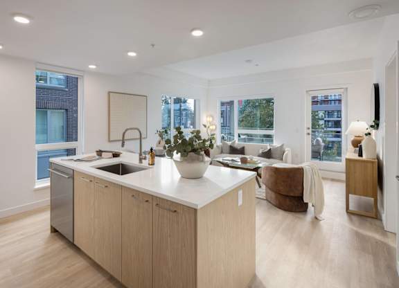 a kitchen and living room in a modern apartment